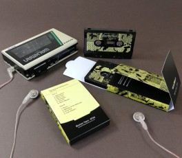 Black cassette tapes in printed Maltese cross folding card boxes
