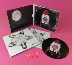 Pink guitar picks and CD digipaks with a booklet for Luna and the Moonhounds