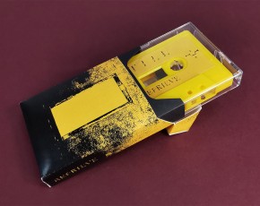 Yellow cassette tapes in clear cases, packed in our cigarette-style outer cases with black inner inserts