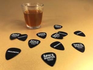 Black guitar picks with full colour printing, produced for Spice Hunter rum