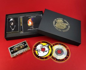 Black A5 box sets with a gold foil lid print and mirror gold cassettes and transparent edge CDs in cases within