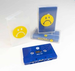 Solid dark blue cassette tapes in clear frosted cases with yellow on-body case prints