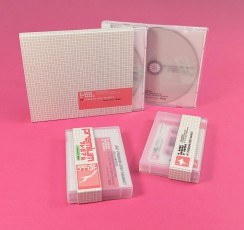 Cassette tapes in clear frosted cases with obi strips and CD jewel cases with white trays, tracing paper inserts and outer O-cards.