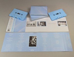 Sky blue cassette tapes in cases with J-cards that have four additional fold-out panels