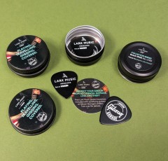 Black guitar pick tins with printed lids and bases, plus guitar picks and printed insert