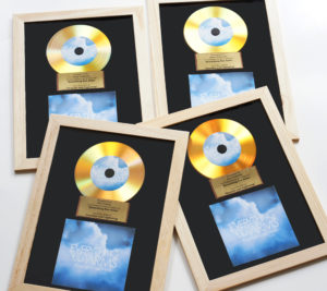 Gold vinyl CDs in an award mount