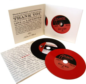 Two vinyl CDs in double record-style four page card sleeves