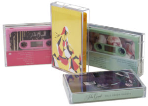 A set of three different colour cassettes in baby pink, yellow and sage green