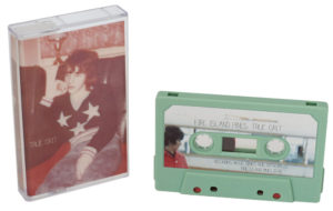 A set of sage green cassettes with printed J-card inserts