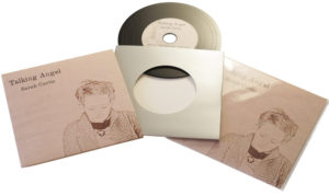 Vinyl CDs in plain silver card wallets with a larger outer printed wallet and finished with cellophane wrapping