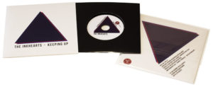 Vinyl CDs in printed card wallets with a larger outer printed wallet and finished with cellophane wrapping