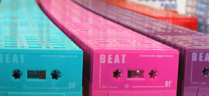 Pre-printed turquoise, hot pink, blackberry purple and red cassettes awaiting recording