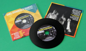 Black vinyl CDs in record-style printed card wallets