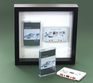 Audio cassette square presentation frame with grey stickered cassette shell and printed cassette case