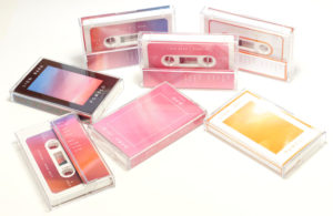 A set of seven different cassette designs and two Japanese import editions for the limited edition Pomelo album