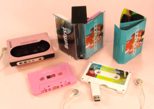 A creative double butterfly case set containing a baby pink audio cassette and white USB cassette drive with additional content