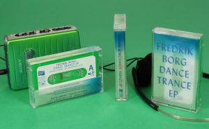 Green cassettes in clear shells that use tracing paper J-cards for a frosted semi-transparent effect