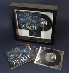 CD digipak in a black presentation frame with printed metal plaque