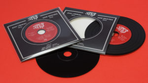 Black vinyl CDs in record-style wallets with fantastic red and black artwork