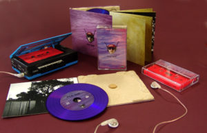 A matching set of purple vinyl CDs in recycled eco digipaks with neon pink cassettes