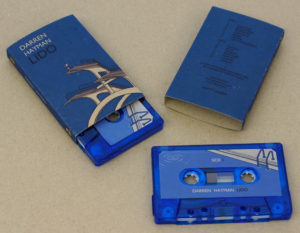 Transparent blue cassettes in printed brown Manila recycled O-cards