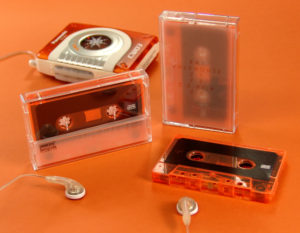 Transparent orange cassette tapes with tracing paper inserts