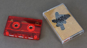 Transparent red cassettes with gold on-body printing and matching J-cards