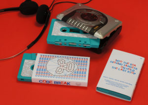 A turquoise cassette with sticker printing in O-cards