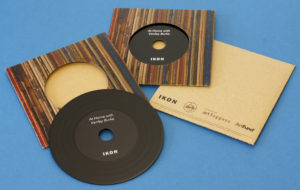 A set of black vinyl CDs in printed card brown Manila record-style wallets