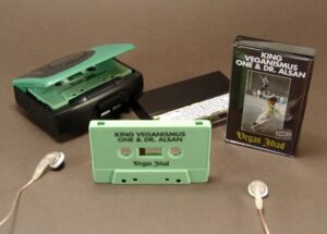 Sage green cassette tapes in black cases with additional J-card panels