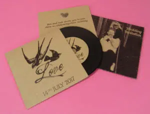 Wedding invitation CDs in brown Manila card wallets, with 2 page printed inserts and black vinyl-style discs