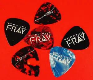 Black, tortoiseshell, red and light blue guitar picks with a white on-body print