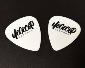 White guitar picks with a black print