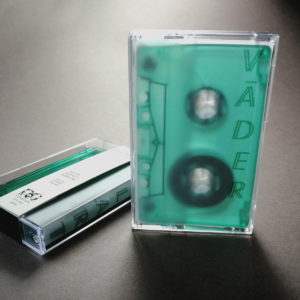 Dark green transparent unprinted cassettes in cases with tracing paper J-cards and Obi strips