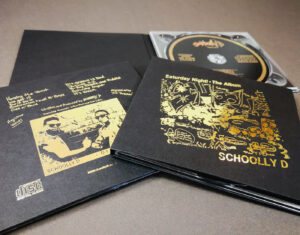 Solid black card CD digipaks with metallic gold foil printing and UV-LED printed gold discs