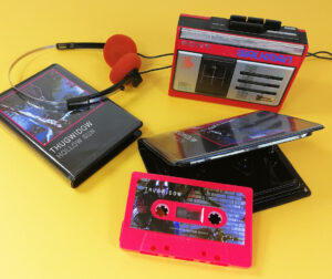 Hot pink cassette tapes with sticker printing and packed in black rave cases