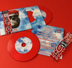 Red vinyl-style CDs in printed premium wallets with record-style inners and obi strips