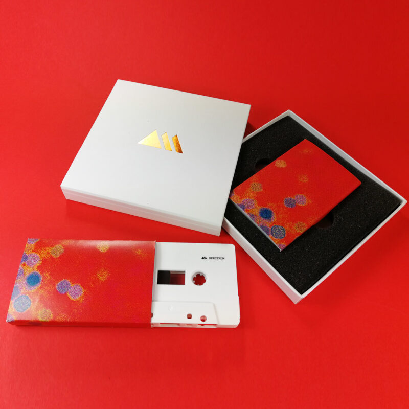 White cassettes with on-body printing, packed in printed O-cards and then in white matchbox presentation cases with a copper foil logo print