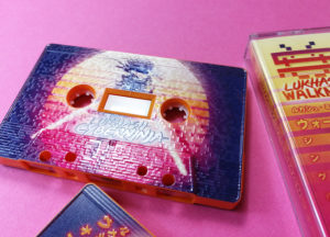 Tangerine orange cassettes with full coverage, full colour printing with a full coverage spot gloss finish