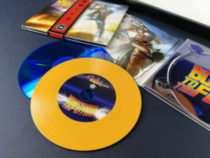 Custom vinyl CDs with orange vinyl rings on a blue base disc for a 'Back to the Future' style release