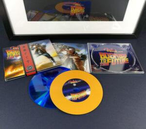 Custom vinyl CDs with orange vinyl rings on a blue base disc for a 'Back to the Future' style release