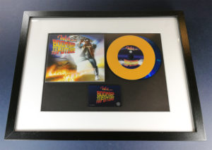 Custom vinyl CDs with orange vinyl rings on a blue base disc for a 'Back to the Future' style release in one of our oversize A4 frames