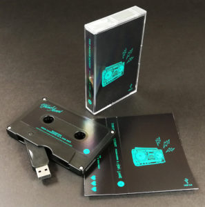 Black USB memory cassette tapes with matching stickers and J-cards, packed in standard tape cases