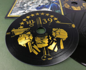 Custom printed full coverage black vinyl CDs with a metallic gold print in premium vinyl wallets