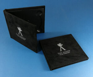 Black velvet hardback digipaks with a white UV-LED print