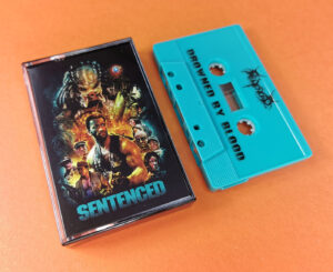 Sentenced 'Drowned by Blood' turquoise cassette tapes with a Predator themed J-card