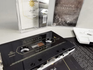 Black and white sandwich tapes with gold on-body printing and a spot gloss over the gold printing