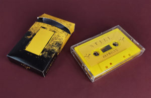 Yellow cassette tapes in clear cases, packed in our cigarette-style outer cases with black inner inserts
