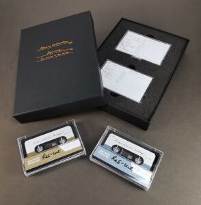 A double cassette box set in an A5 black preentation box with copper hot foil lid printing