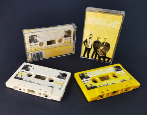 Cream and yellow cassette tapes produced for All Time Low and their 'Wake Up Sunshine' release on Warner Records